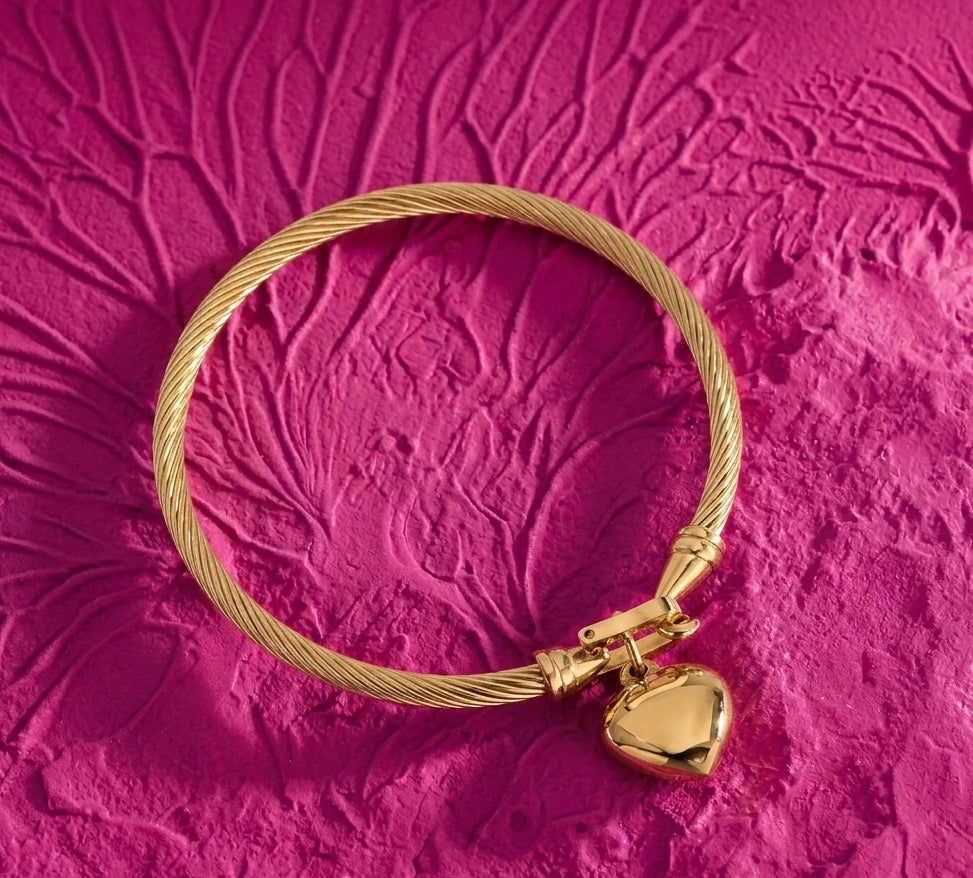 Golden knot statement bangle with heart charm